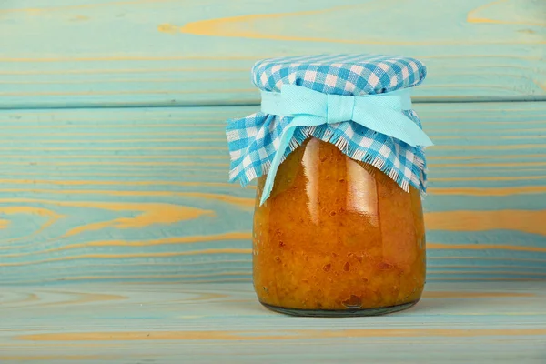 One jar of quince jam at blue vintage wood surface — Stock Photo, Image