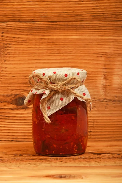 Jar of pepper salad at vintage wood surface — Stock Photo, Image