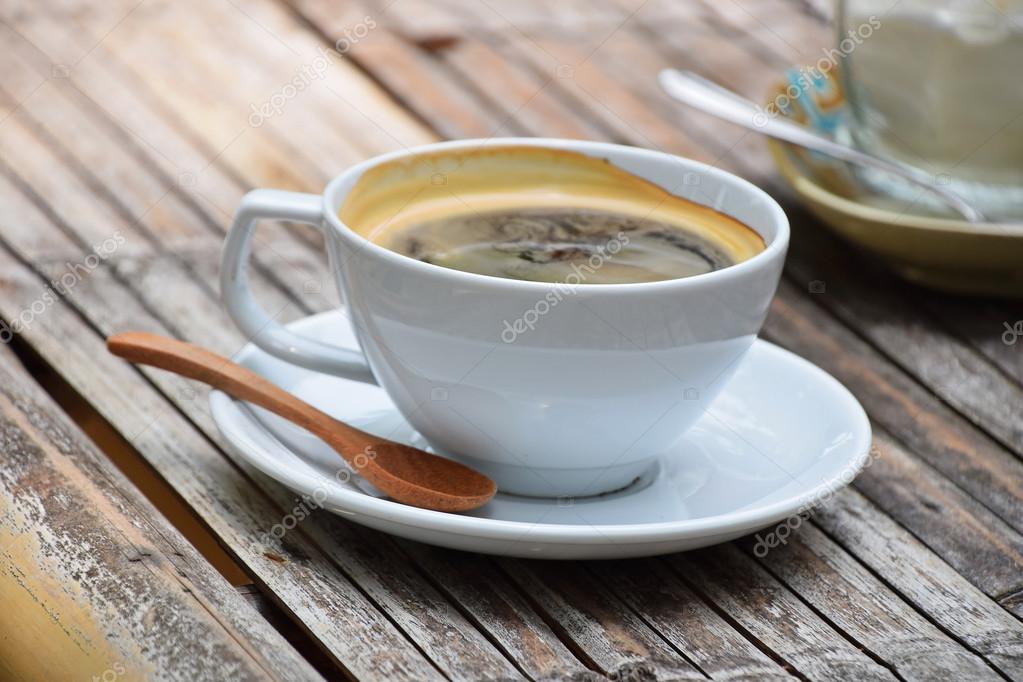 Eine volle Tasse amerikanischer Kaffee auf einem Bambustisch
