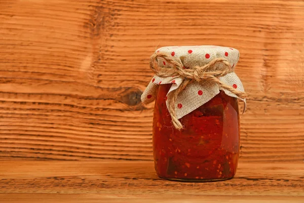 Jar of pepper salad at vintage wood surface — Stock Photo, Image