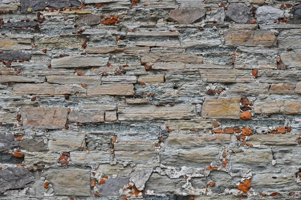 Gamla sten layered vägg — Stockfoto