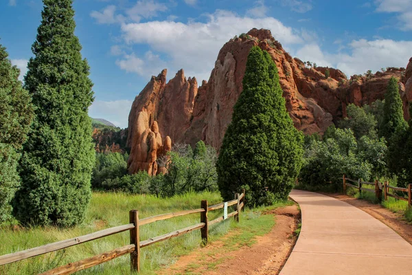 Fenced path surrounded by rock formations in a park in Colorado