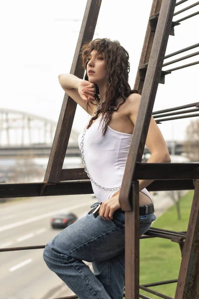 Curly girl in a white bodysuit