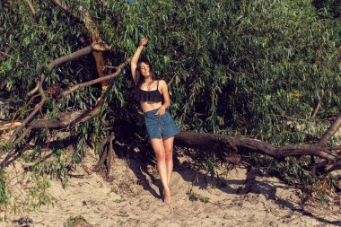 Nehrin kenarındaki kumda bir kız