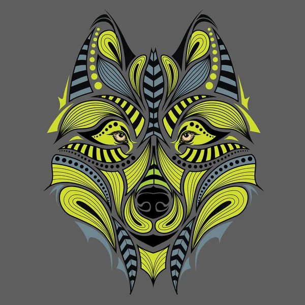 Patterned colored head of the wolf. African / indian / totem / tattoo design. It may be used for design of a t-shirt, bag, postcard and poster. — Stock Vector