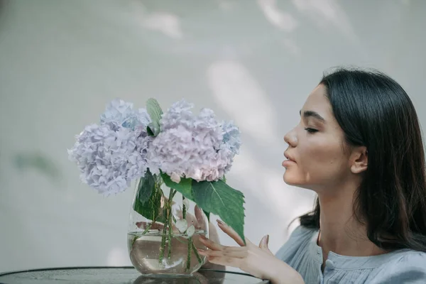 Meisje Aanraken Hortensia Bloemen Vaas Decoratieve Glazen Tafel — Stockfoto