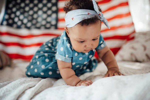 Lovely Little Girl Blue Dress Sitting Sofa American Flag Background — Stock Photo, Image