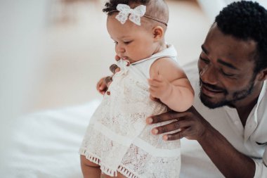 african american man with his daughter at home