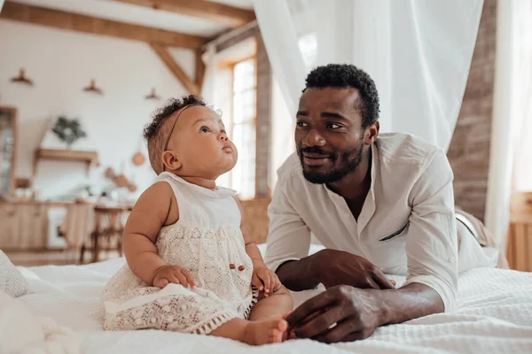 young black man and mixed race daughter with digital tablet 