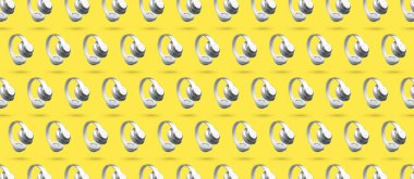 Ultimate Gray kablosuz kulaklıklar sarı arkaplanı aydınlatıyor. Yatay desen, bölge başlığı. Yılın renklerinde havada asılı kalma anti-yerçekimi aleti