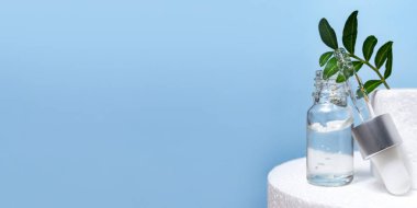 Mavi Arkaplanda şeffaf cam şişe ve Pipette kozmetik serumu. Face, Cilt Bakımı Organik Güzellik Spa konsepti. Beyaz Sahne Malzemeleri. Podyum reklamı. Yaşlanma Karşıtı Yüz afişi şablonu.