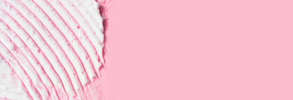 White smear of foam on pink background. Cosmetic of selfcare procedure. Beauty macro bubble texture wallpaper. Creme, shaving foam, mask, beauty product swatch closeup banner.