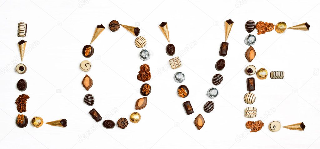Word Love made of little chocolates in shape of letters and heart