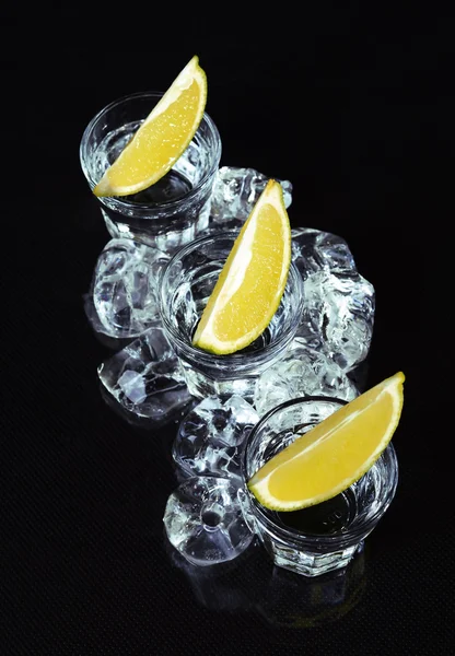 Vodka with lime on black background. — Stock Fotó