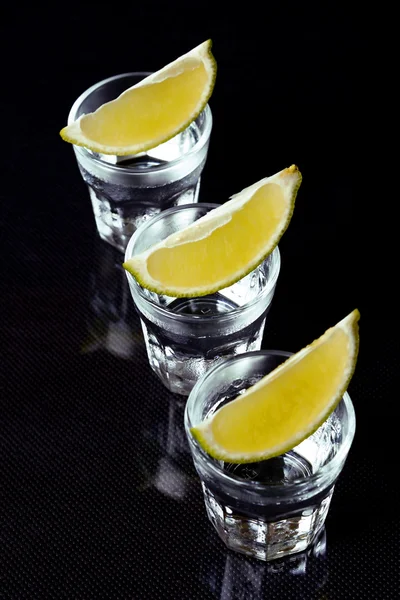 Tequila with lime on black background. — Stock Photo, Image