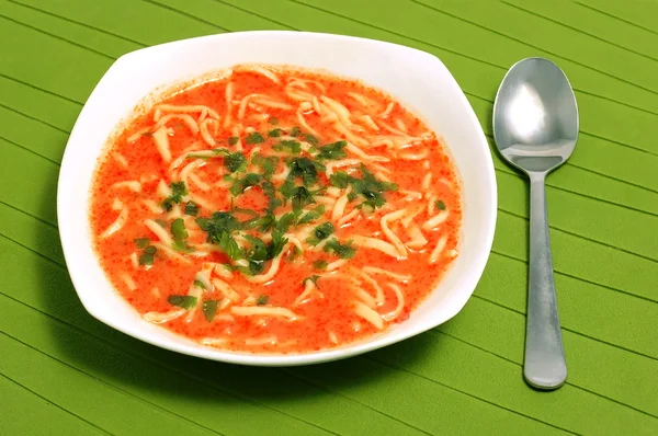 Traditional homemade tomato soup with noodles.
