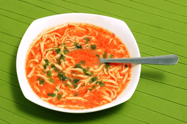 Plate of home-made tomato soup with noodles