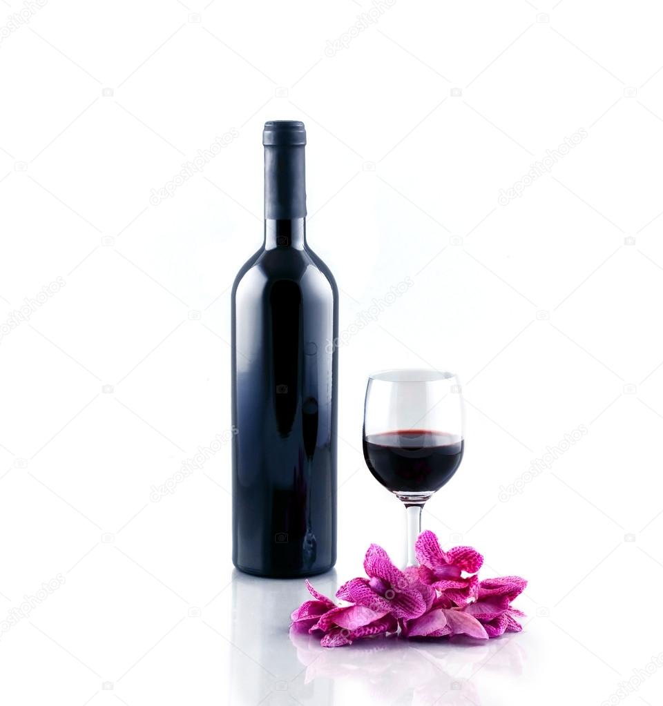Bottle and glass of red wine isolated on white background.