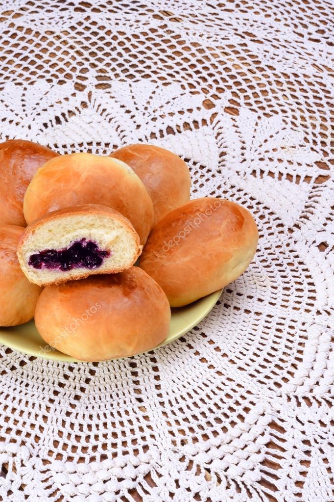 Several yeast rolls with blueberry jam.
