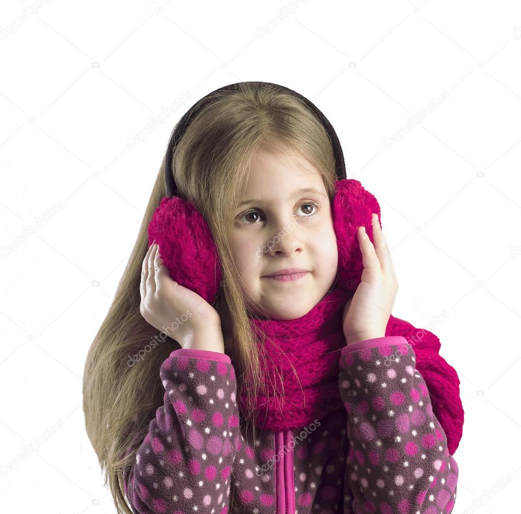 Portrait of a girl in earmuffs and scarf. Isolated background.