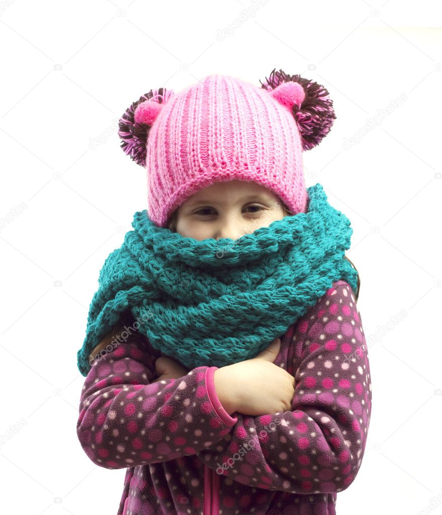 Portrait of a girl in a cap and scarf . Isolated background.