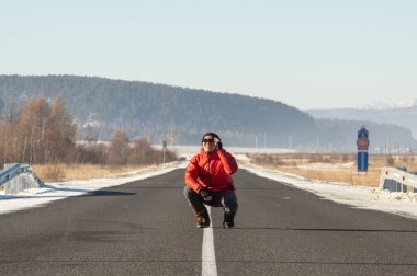 Arshan, Buryatia, Russia - Decembar 2020: a man in warm clothing on the country road