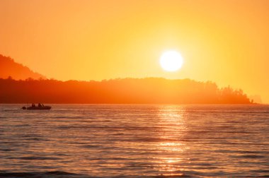 boat trip at the orange sunset colours