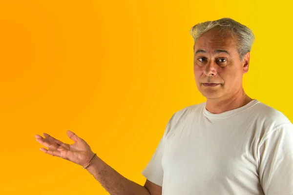 Homem Cabelos Grisalhos Mostrando Algo Com Mão Fundo Amarelo Laranja — Fotografia de Stock
