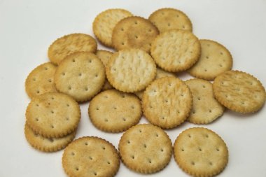 Beyaz zemin üzerinde tuzlu yuvarlak şekilli kurabiyelerin yukarıdan yakın plan görüntüsü