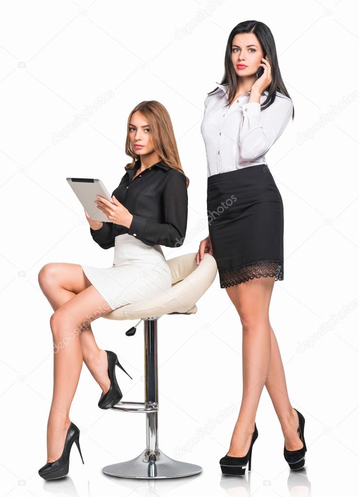 Two office women with gadgets isolated on white background