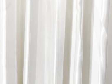 Perde dokusunun yüzeyinde gri-beyaz bir ton var. Duvar kağıdı veya arkaplan resmi için bunu kullanın. Metin için boş bir boşluk var.