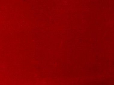 Arka plan olarak kırmızı kadife kumaş dokusu kullanılıyor. Yumuşak ve pürüzsüz tekstil malzemelerinden oluşan boş kırmızı kumaş arka plan. Metin için boşluk var.