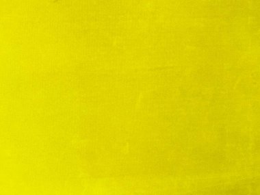 Arka plan olarak kullanılan sarı kadife kumaş dokusu. Yumuşak ve pürüzsüz tekstil malzemelerinden oluşan boş sarı kumaş arka plan. Metin için boşluk var.