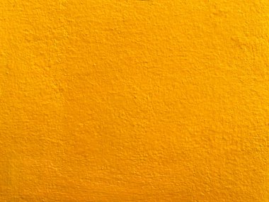 Sarı beton duvarın pürüzsüz dokusu kaba bir yüzey, metin için boşluk, arkaplan için alan.