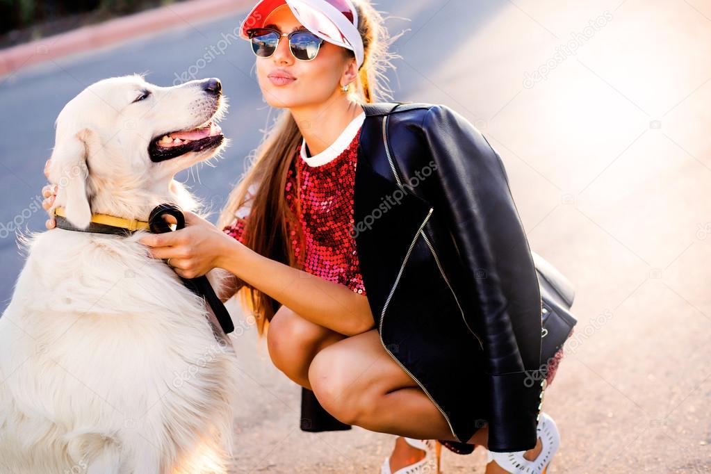 Portrait of woman playing with dog