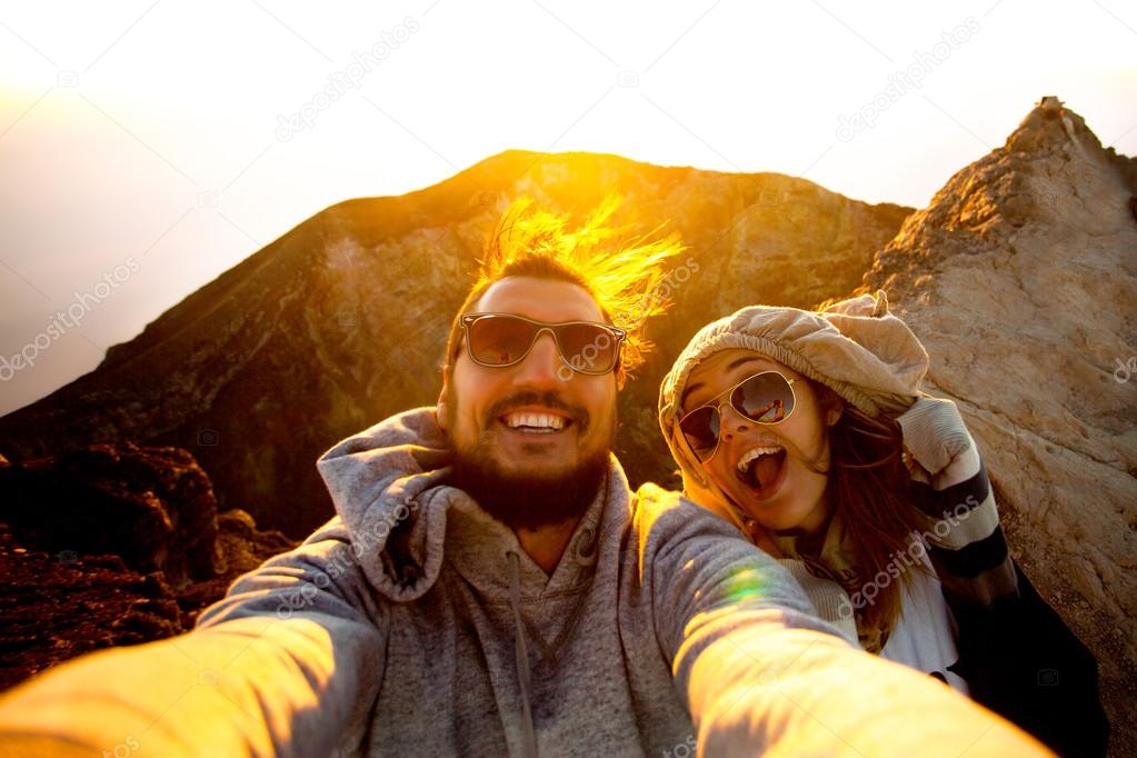 Beautiful traveling couple on the top of the mountain