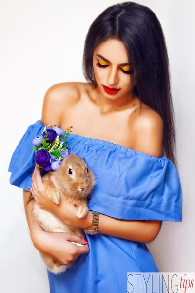 Mujer atractiva con conejo y flores — Foto de Stock