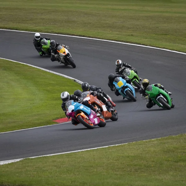 A shot of a racing motorbike as it circuits a track.