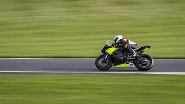 Una Toma Panorámica Una Moto Carreras Mientras Circula Una Pista —  Fotos de Stock
