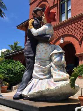 Close-up of colorful sculpture of dancing couple in front of historic building in Key West