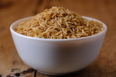 Kase içinde çiğ kahverengi pirinç.