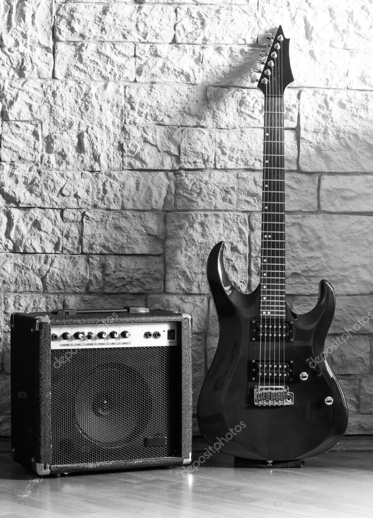 Guitar and amplifier on a stone background