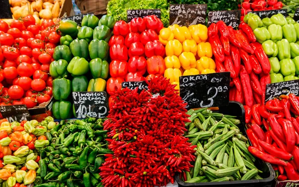 Red, green, yellow peppers at the food market