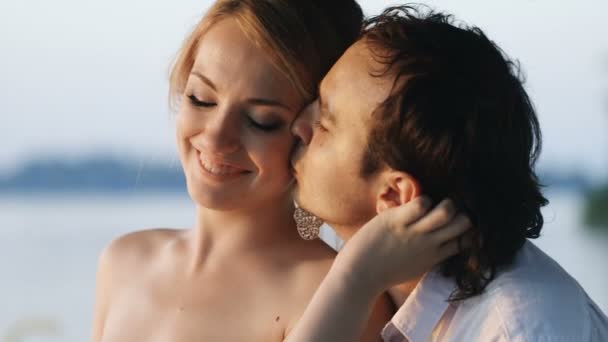 Novomanžele pár sledovat západ slunce, líbání — Stock video