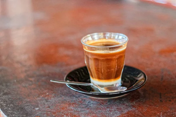 A glass of hot coffee with milk mixture in the afternoon.