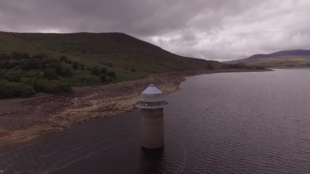 Llyn Celyn 2018の干ばつの間に摂取塔に向かってゆっくりと飛行する空中ショット — ストック動画