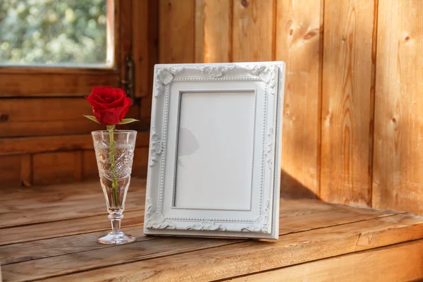 Fotoğraf çerçevesi ve bir kırmızı gül