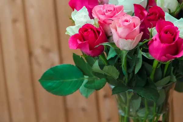 Vase with flowers standing near the window