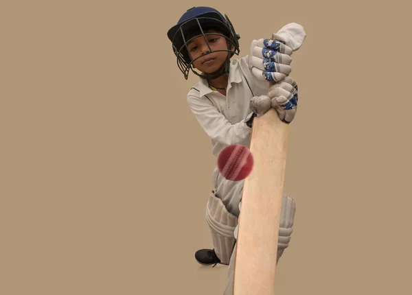 A boy in cricket uniform playing Cricket