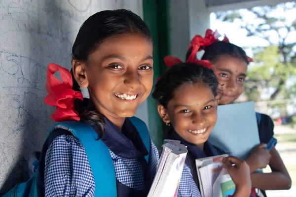 Indian Rural School Girls Holding Books Standing in School